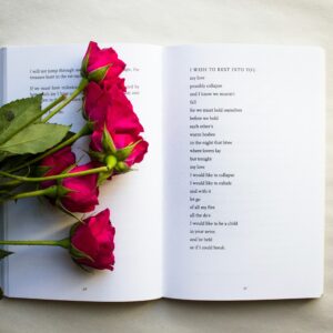 Open poetry book with roses