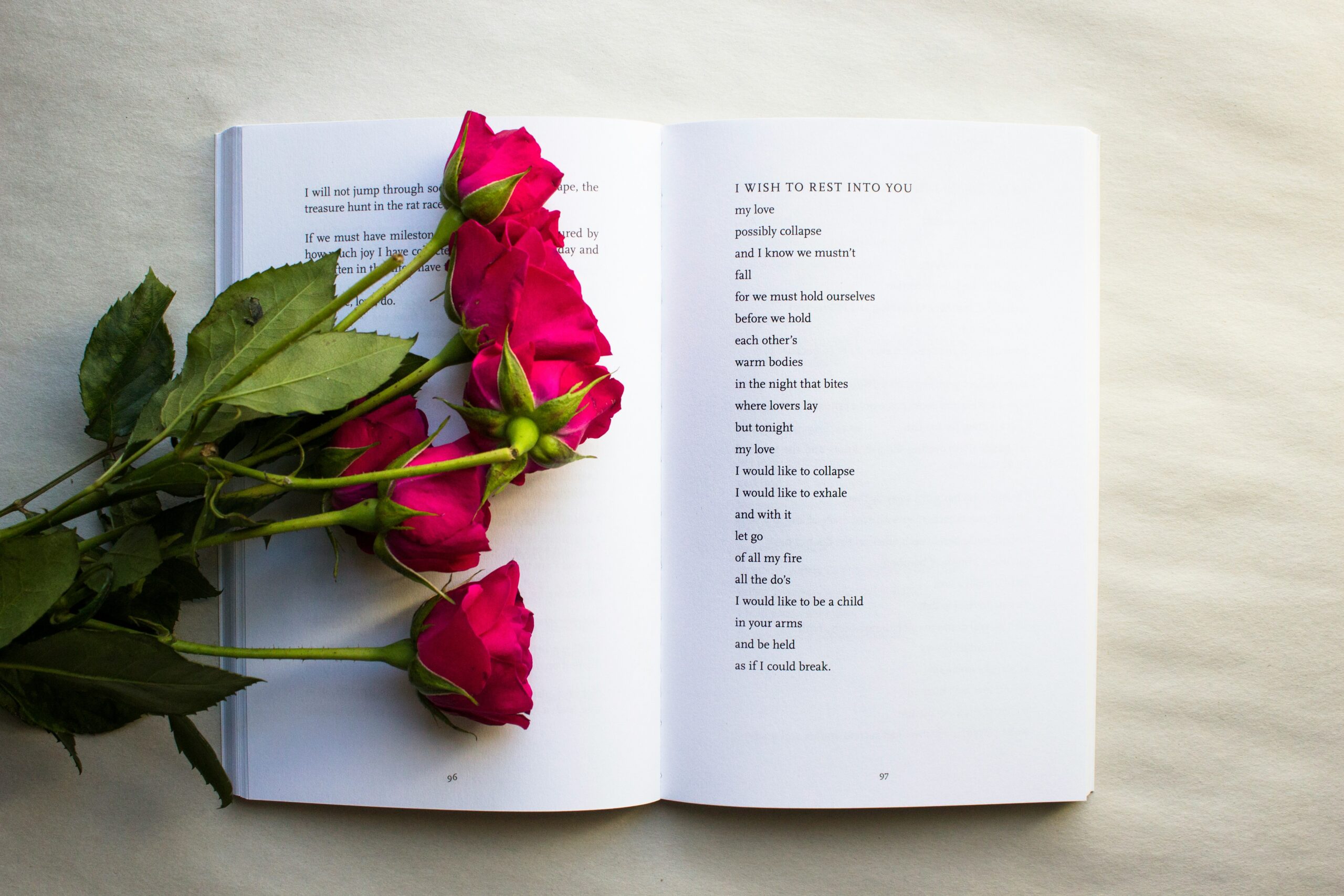 Open poetry book with roses