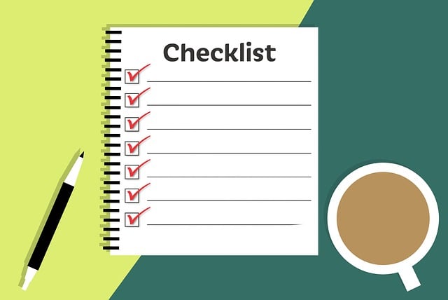 A checklist with a pen and cup of coffee on a blue and green background