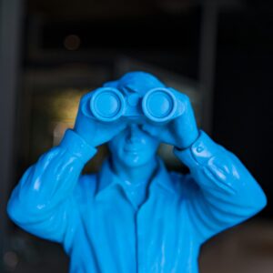 Blue statute with binoculars for mystery genre